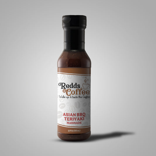 A bottle of Redds Coffee Asian BBQ Sauce with the label clearly showing the product name and the flavor, standing against a plain background.