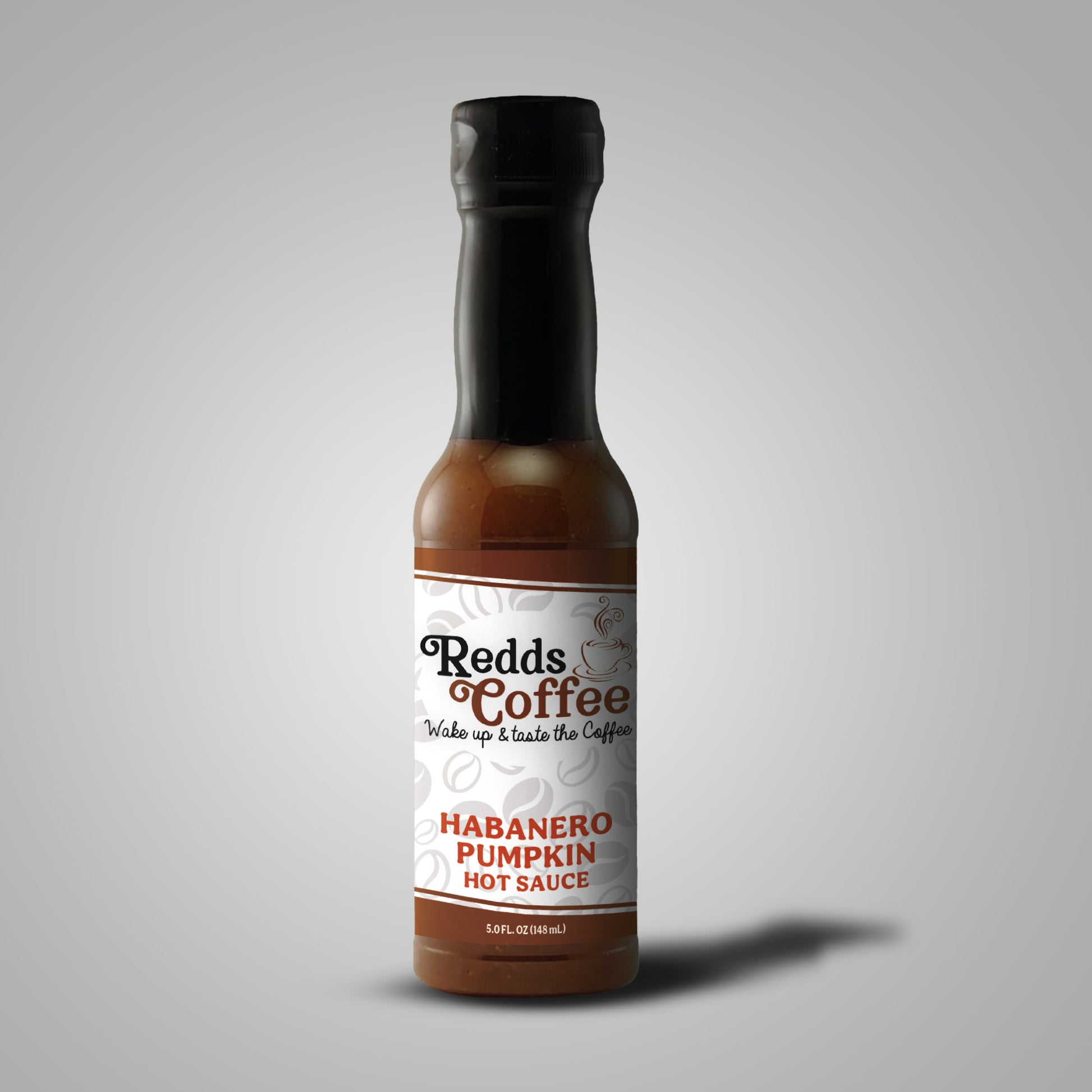 A bottle of Redds Coffee Habanero Pumpkin Hot Sauce against a plain background, front side.