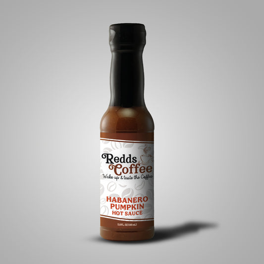 A bottle of Redds Coffee Habanero Pumpkin Hot Sauce against a plain background, front side.